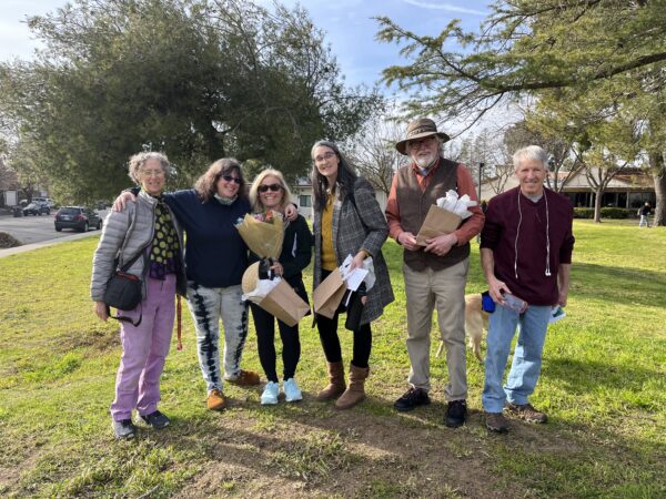 Photo shows a group of adult volunteers from the Hope River project standing together, including Davis Poet Laureate Julia Levine.